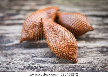 Salak On Wooden Background / Salak Tropical Fruit Salacca Zalacca Or Snake Fruit Palm