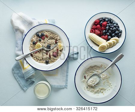 Eating Porridge Oatmeal With Fruits, Berries, And Honey. Concept Of Healthy Breakfast, Wellbeing, He