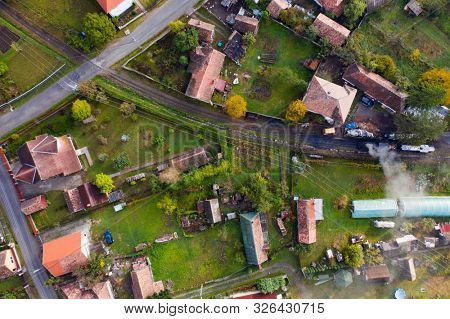 Aerial view of a small train station and houses arround.