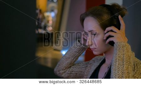 Woman Using Headphones And Listening Audio Guide At Modern Jewish History Museum. Education And Tech