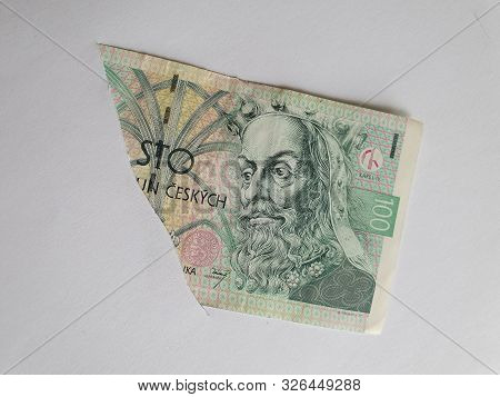 Czech Banknote Of 100 Korun On The Broken Sheet Of Paper