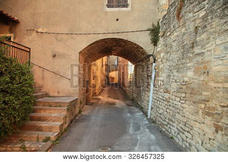 Narrow Street With Stone Pavement Of Old Town Of Barjac. European Old Town At Sunset, South France