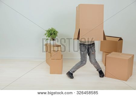 Funny Man Is Standing With Cardboard Box On His Head, Hesitating, Not Seeing Where To Go. Handsome Y