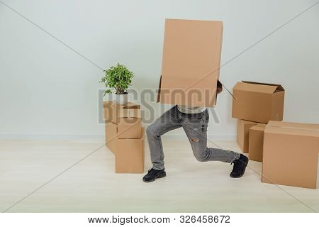 Funny Man Is Standing With Cardboard Box On His Head, Hesitating, Not Seeing Where To Go. Handsome Y