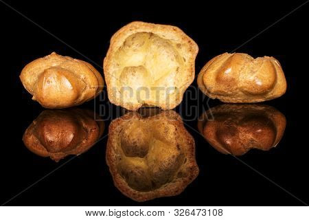 Group Of Two Whole One Half Of Baked Golden Profiterole Isolated On Black Glass
