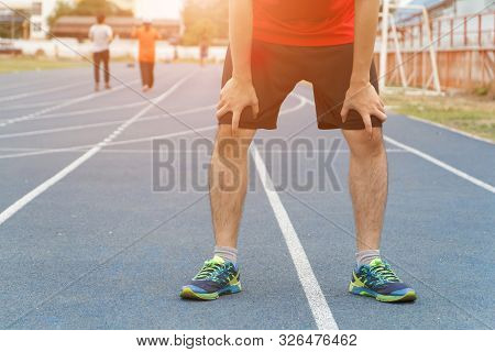Tired Young Man Runner Taking A Rest After Running.workout Concept, Running Concept