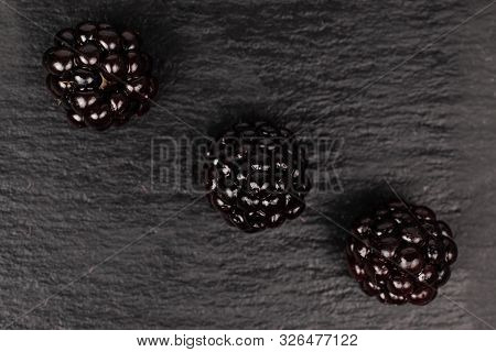 Group Of Three Whole Fresh Black Blackberry Flatlay On Grey Stone