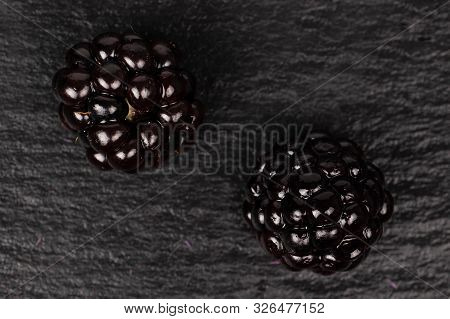 Group Of Two Whole Fresh Black Blackberry Flatlay On Grey Stone