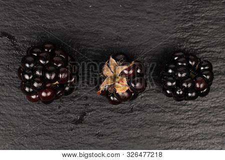 Group Of Three Whole Fresh Black Blackberry Flatlay On Grey Stone