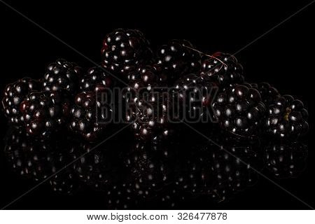 Lot Of Whole Fresh Black Blackberry Heap Isolated On Black Glass