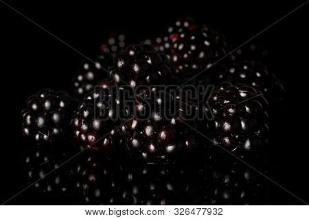 Lot Of Whole Heap Fresh Black Blackberry Isolated On Black Glass