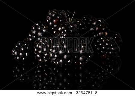 Lot Of Whole Fresh Black Blackberry Isolated On Black Glass