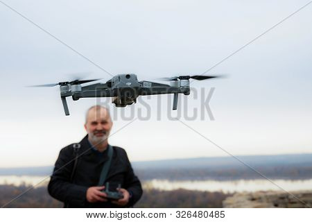 Elabuga, Russia, October 6, 2019: A Smiling Man Launches A Copter. The Copter Is In The Foreground, 