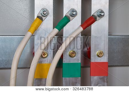 Three Electric Cable Is Connected To The Vertical Aluminum Busbars In The Electrical Control Panel B