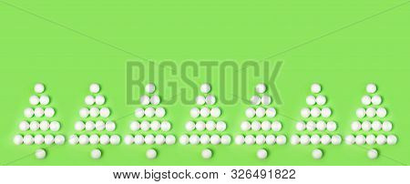 Anner. Silhouette Of Christmas Trees Made Of White Christmas Toys On A Green Background. Creative De