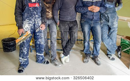 Workers And Builders And Foreman Are As Gang With Dirty Uniform Are Staying In Apartment That Is Und