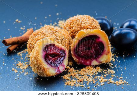 Plum Dumplings. Traditional Homemade Sweet Plum Dumplings With Crumble And Cinnamon.