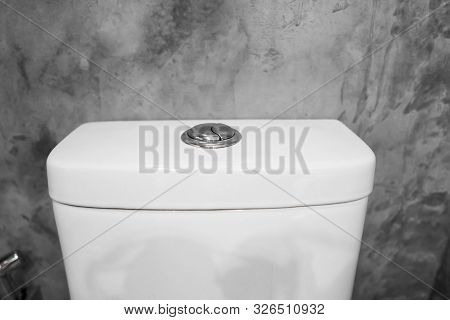 Close Up On A Flush Toilet Button For Cleaning A Toilet.
