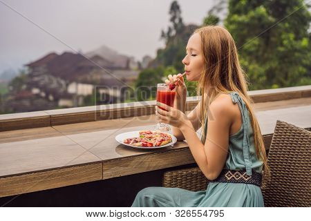 Woman Eating Delicious Strawberry Pizza On A Balinese Tropical Nature Background. Bali Island, Indon