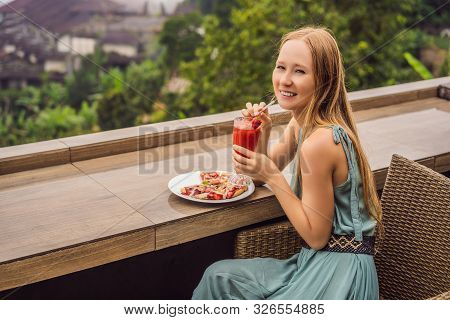 Woman Eating Delicious Strawberry Pizza On A Balinese Tropical Nature Background. Bali Island, Indon