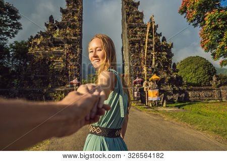 Tourist Woman Walking Through Traditional Balinese Hindu Gate Candi Bentar Close To Bedugul, Bratan 