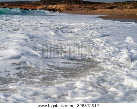 Foam And Waves In The Sea On A Sunny Day. Foam And Waves In The Sea. Powerful Waves Crushing For Bac
