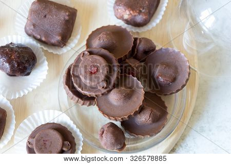 Homemade Raw Chocolate Sweet Candies With Raspberries Inside With Droplets Of Water And Raspberry Ju