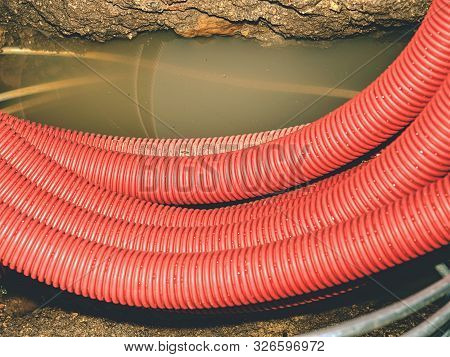 Detail Of Pvc Ribbed Tube Ready For Using Under Ground, Leaves On Wet Siol.