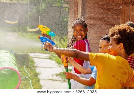 Girl Smile Holding Water Gun In Group Kids Game