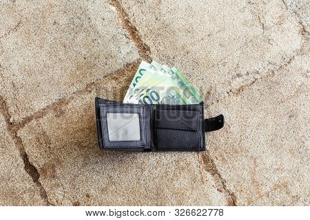 Lost Black Leather Wallet With Money Euro On Street. One Hundredth Banknotes Inside It