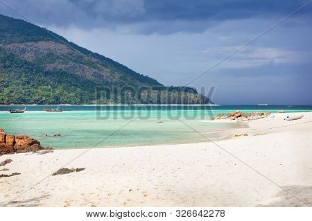 Paradise Beach In Thailand During Storm With Tall Palms