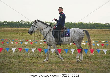 Samara, Russia - August 17, 2019: Young Cossack In Traditional Costumes On Horseback