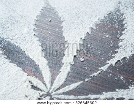 Cooking Cannabis Food. Trail Of Cannabis Leaf On White Flour. On A Wooden Table