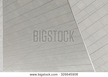 Ripped Gray Shaped Surface Of Building Roof Or Wall Of City Business Centre. Medern Architecture Dec