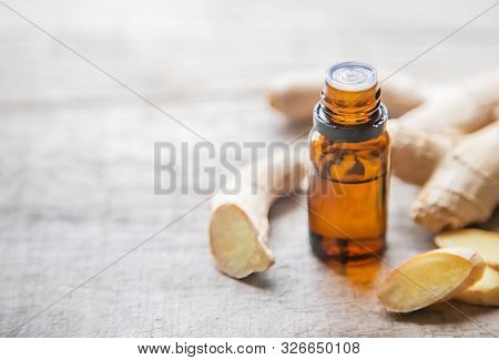 Ginger Essential Oil In A Small Bottle. Selective Focus.