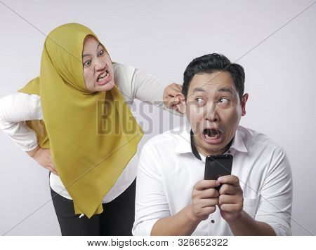 Muslim Couple Having Fight, Jealous Wife Finds Her Husband Cheating On Mobile Phone. Couple Conflict