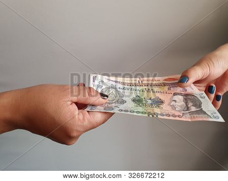 Women Hands Paying And Receiving Honduras Money