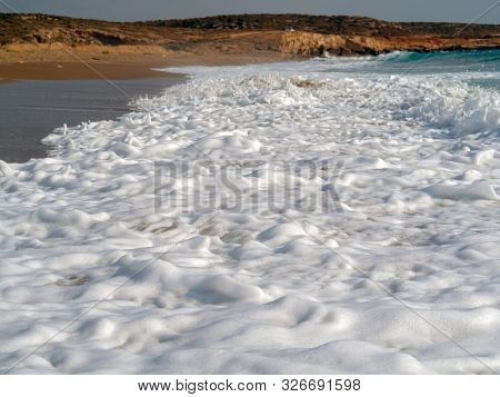 Foam And Waves In The Sea On A Sunny Day. Foam And Waves In The Sea. Powerful Waves Crushing For Bac