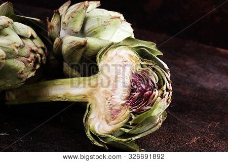 Artichokes On Rustic Dark Background. Fresh Organic Artichoke Flower.