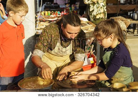 Moldavian, Krymsk, Russia-05 October 2019: Master Potter Teaches A Girl To Make A Pitcher Of Clay. C