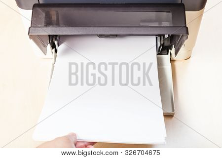 Loading Of Blank Paper Sheets In Printer Tray Of Multi Function Device On Table In Office