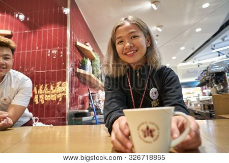 HONG KONG, CHINA - CIRCA JANUARY, 2019: indoor portrait of a barista at Pret a Manger. Pret a Manger is an international sandwich shop chain based in the United Kingdom.