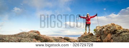 mature backpacker enjoying reaching a mountain top - Horsetooth Rock trail above Fort Collins in northern Colorado, panorama