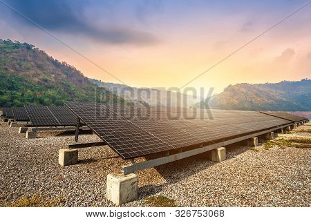 Solar Panels With Against View Of The Reservoir And Mountanis Landscape Against During Sky Sunset,al