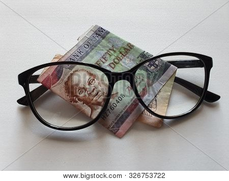 Investment And Promotion For A Better Vision, Jamaican Banknote Of Fifty Dollars And Black Plastic F