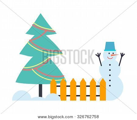 Snowman Winter Holiday Character In Bucket Standing Near Fence With Decorated Christmas Tree. Funny 
