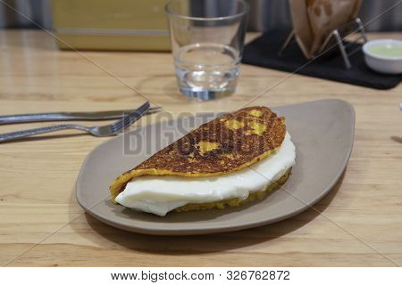 Cachapa With Cheese, Typical Venezuelan Dish Made With Corn, Cheese And Butter On Stone Plate