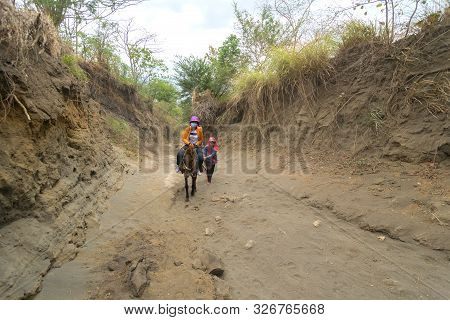 Tagaytay, Philippines - April, 6, 2017: Tourists Riding Horses On Hiking Trekking Tour Trail To Taal