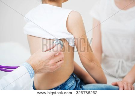 Pediatrician Examining Little Child With Stethoscope. Medical Examination Of Little Girl. Profession