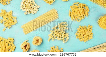 A Panorama Of Italian Pasta Variety, Flat Lay Banner, Shot From The Top On A Teal Blue Background